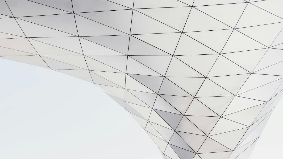 Low angle view of a modern geometric architectural structure with triangle patterns.