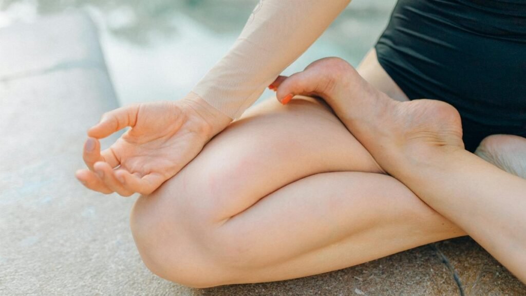 Close-up of a person meditating outdoors, focusing on a serene yoga pose for relaxation.