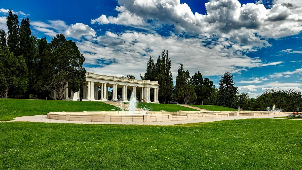 Beautiful pavilion and fountain in Cheesman Park, Denver, under a vibrant summer sky.