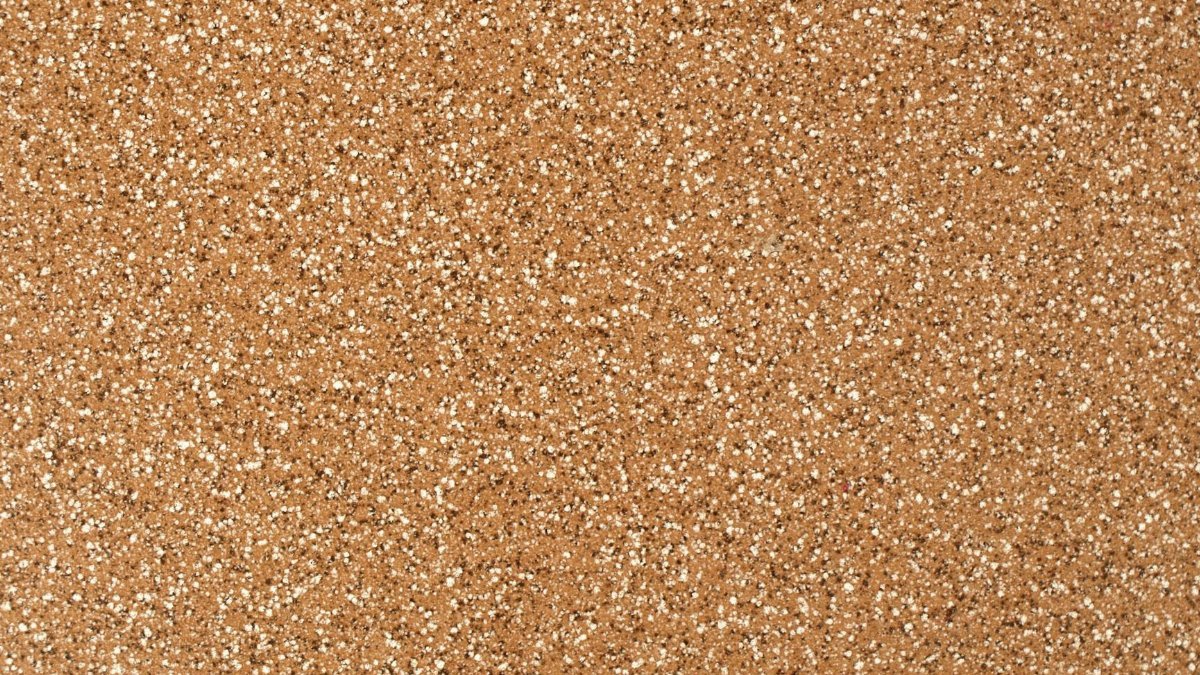 Close-up view of a granular sandstone surface texture, ideal for backgrounds.