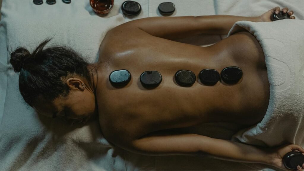 A serene spa scene with hot stone massage therapy focusing on health and relaxation.