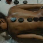 A serene spa scene with hot stone massage therapy focusing on health and relaxation.