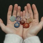 A close-up image of chakra stones held in open hands, showcasing spiritual balance.