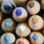Close-up of vibrant colored pencils viewed from the top, showcasing sharpened tips.