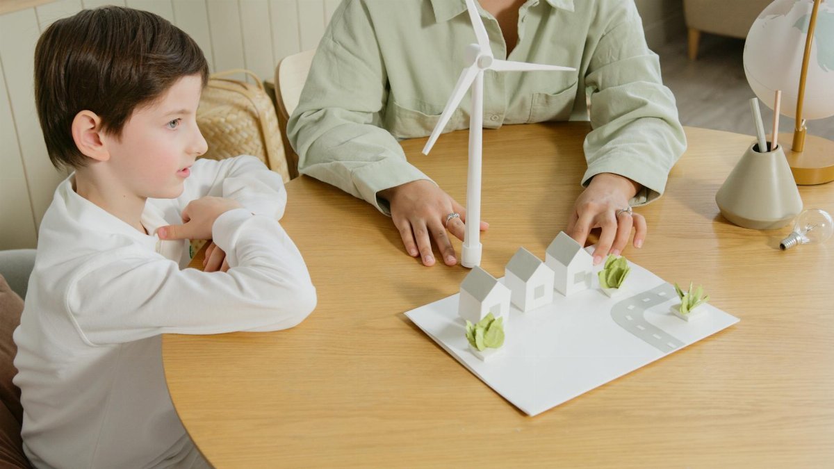 A child explores renewable energy models in a classroom setting.