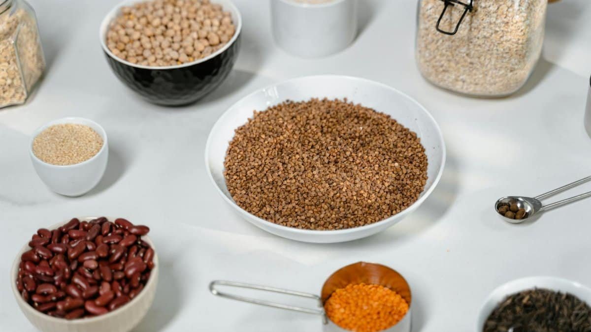 A collection of grains and legumes in various bowls and jars, perfect for culinary inspiration.