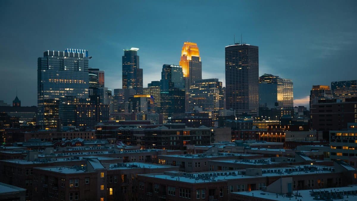 Captivating night skyline of Minneapolis showcasing illuminated skyscrapers and urban architecture.