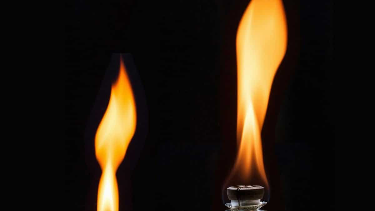 A detailed shot of a bright flame from a lighter against a dark backdrop. Captures the essence of heat and light.