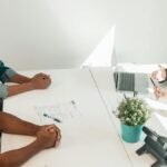 Two adults consulting a legal advisor in a modern office setting.