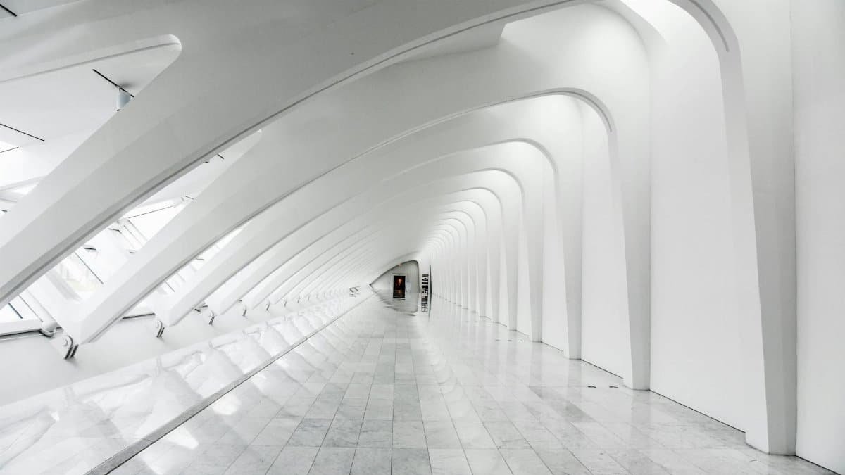 Explore the sweeping modern arches and minimalistic design of the Milwaukee Art Museum's white hallway.