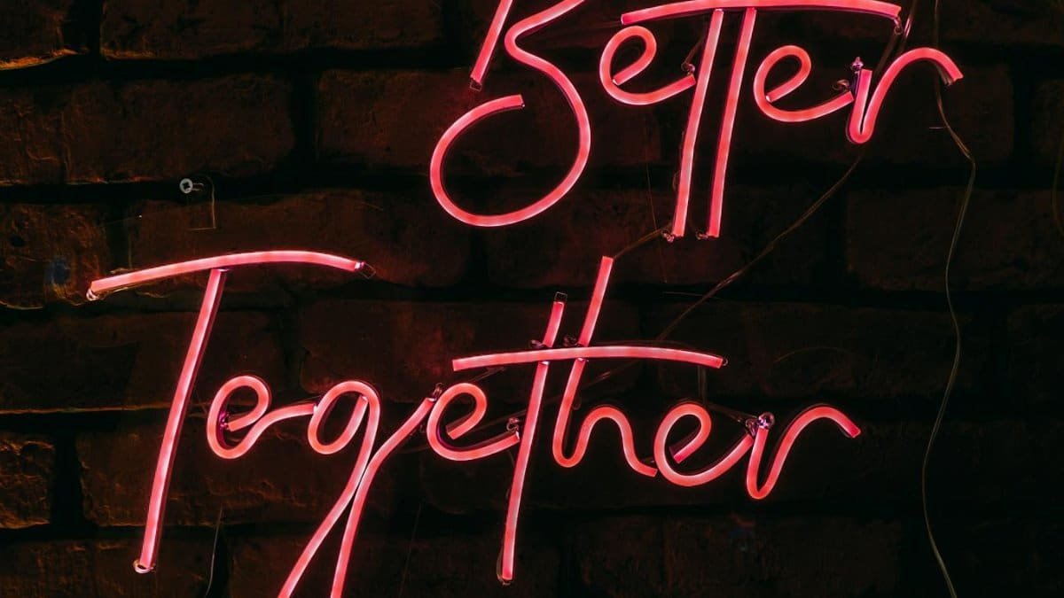 Illuminated neon sign 'Better Together' glowing against a rustic brick wall in Istanbul.