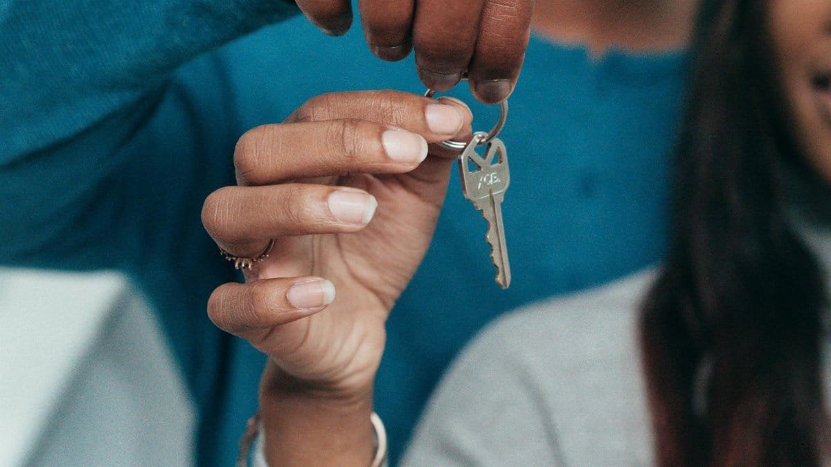A couple holding a key, symbolizing a new home ownership or rental.