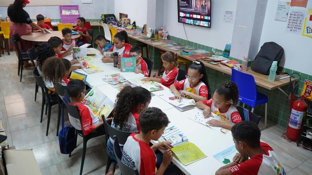 Children engaged in reading at a community library in Glória do Goitá, Brazil.