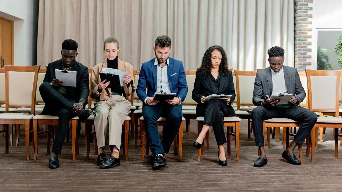 A diverse group of professionals attentively reviewing documents indoors.