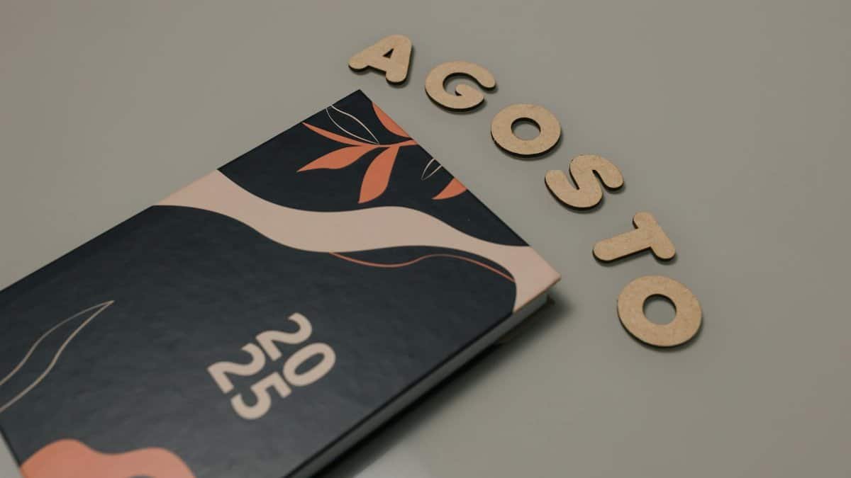 A stylish 2025 planner alongside wooden letters spelling 'August'. Perfect for organization themes.