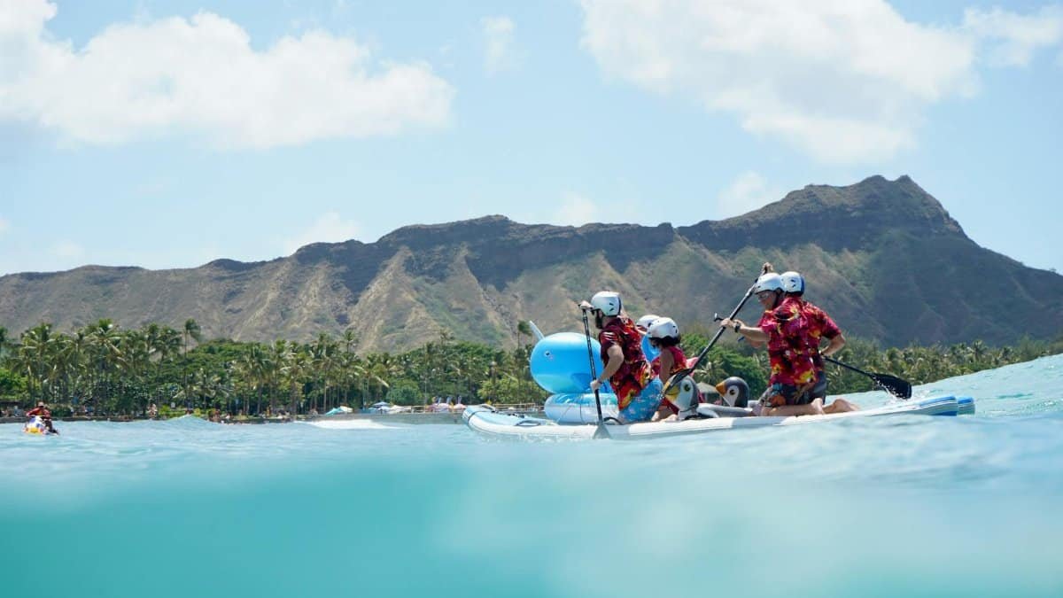 Colorful group paddling near Diamond Head, Honolulu on a sunny day.