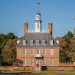 Historic Governor's Palace in Colonial Williamsburg surrounded by autumn foliage.