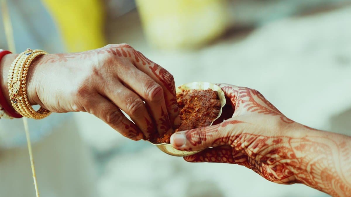 Close-up of hands with henna during a traditional Indian wedding ritual in Delhi.