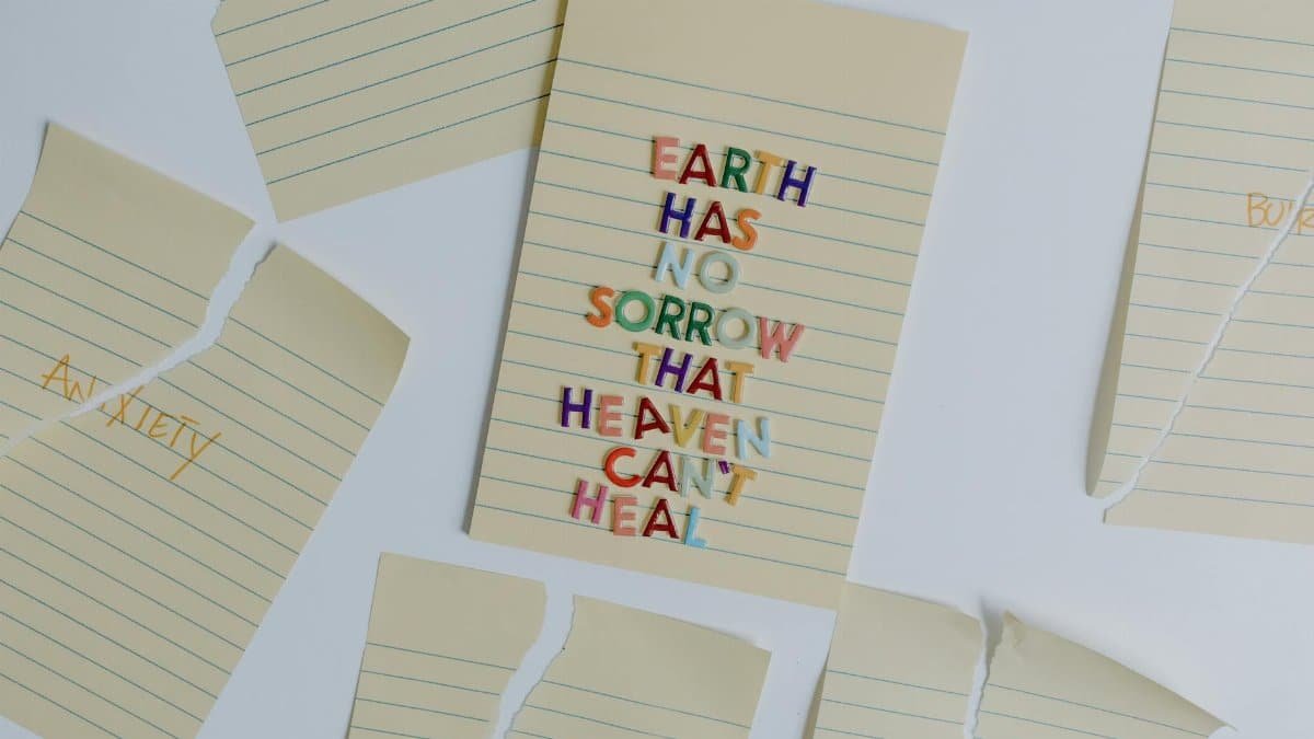 Creative flat lay of inspirational quote with torn paper emphasizing healing and mental health.