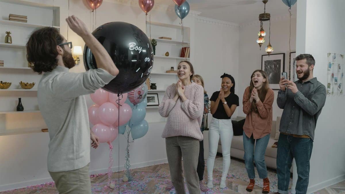 A lively gender reveal party with friends, balloons, and excitement as the big moment unfolds.