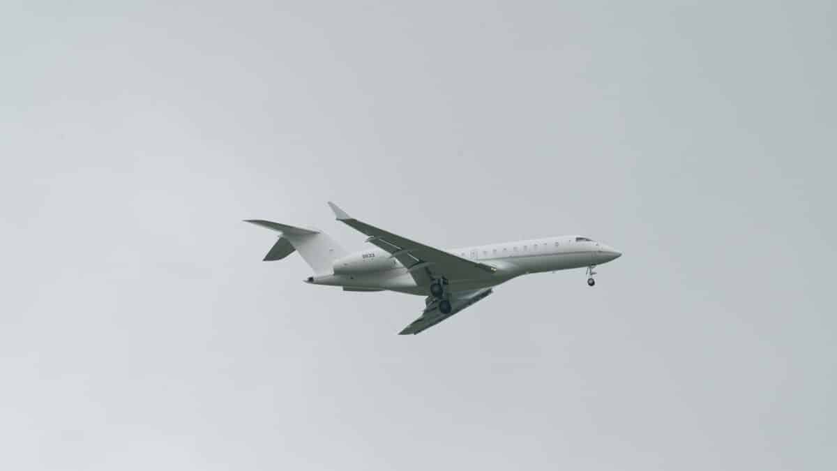 A commercial jetliner flying against a cloudy sky, captured in Poprad, Slovakia.