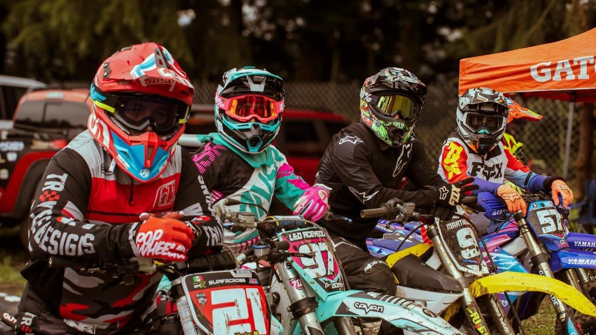 Motocross riders in vibrant gear lined up at La Marquesa competition. Vibrant energy and focus.