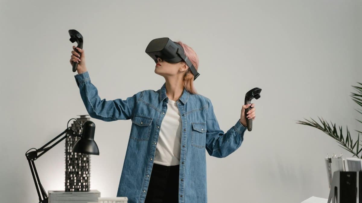 Woman engaging with VR technology in a modern workspace, exploring virtual reality.