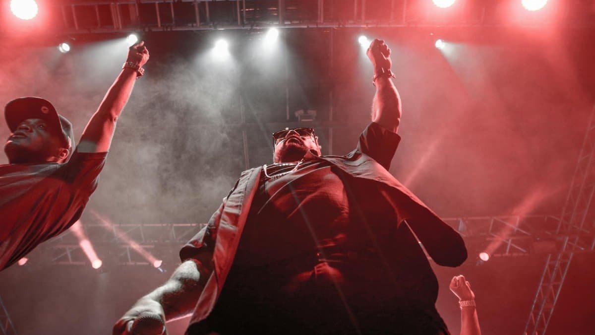 Dynamic stage performance with vibrant red lighting and audience engagement.