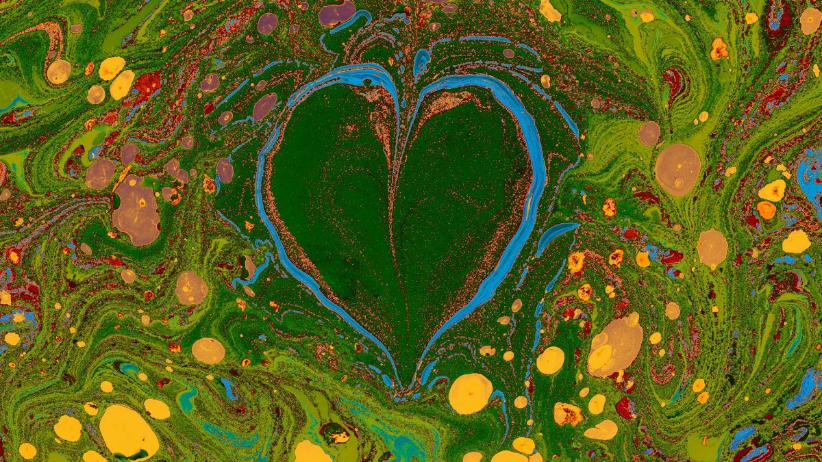 Colorful fluid acrylic painting with a heart design, showcasing vivid abstract patterns.