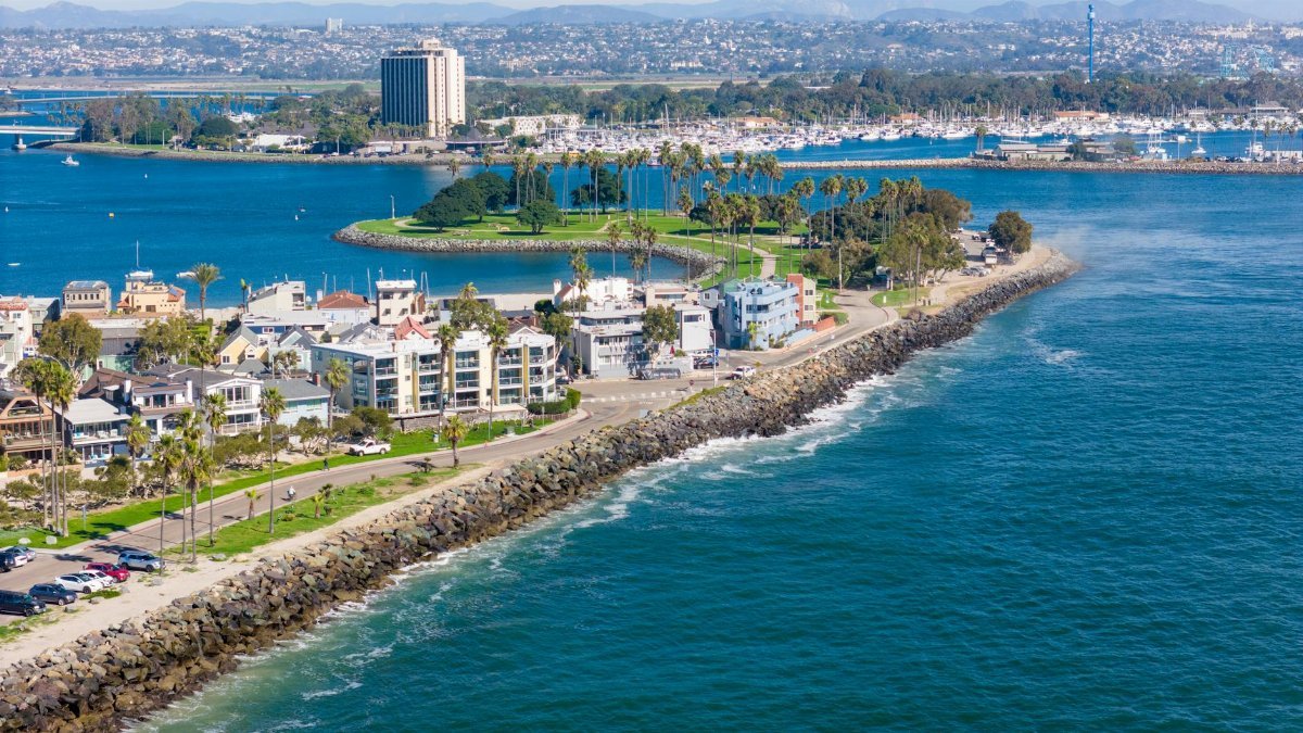 Stunning drone shot of San Diego's coastline, showcasing urban cityscape and ocean views.