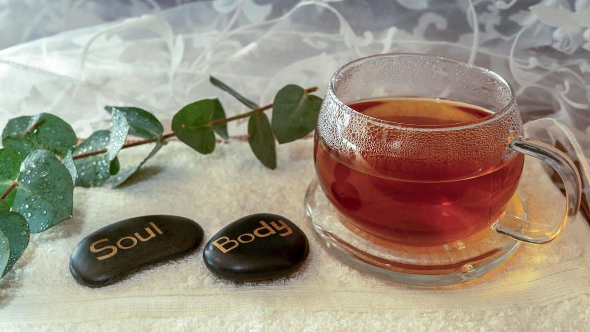 Relaxing scene with herbal tea and stones symbolizing soul and body harmony.