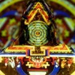 Vibrant projection on woman depicting mystical patterns and spiritual symbols.