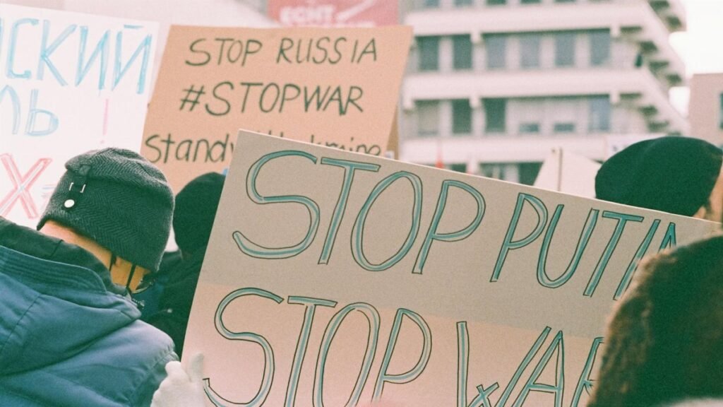 Protest signs at a rally expressing anti-war and anti-Putin sentiments.