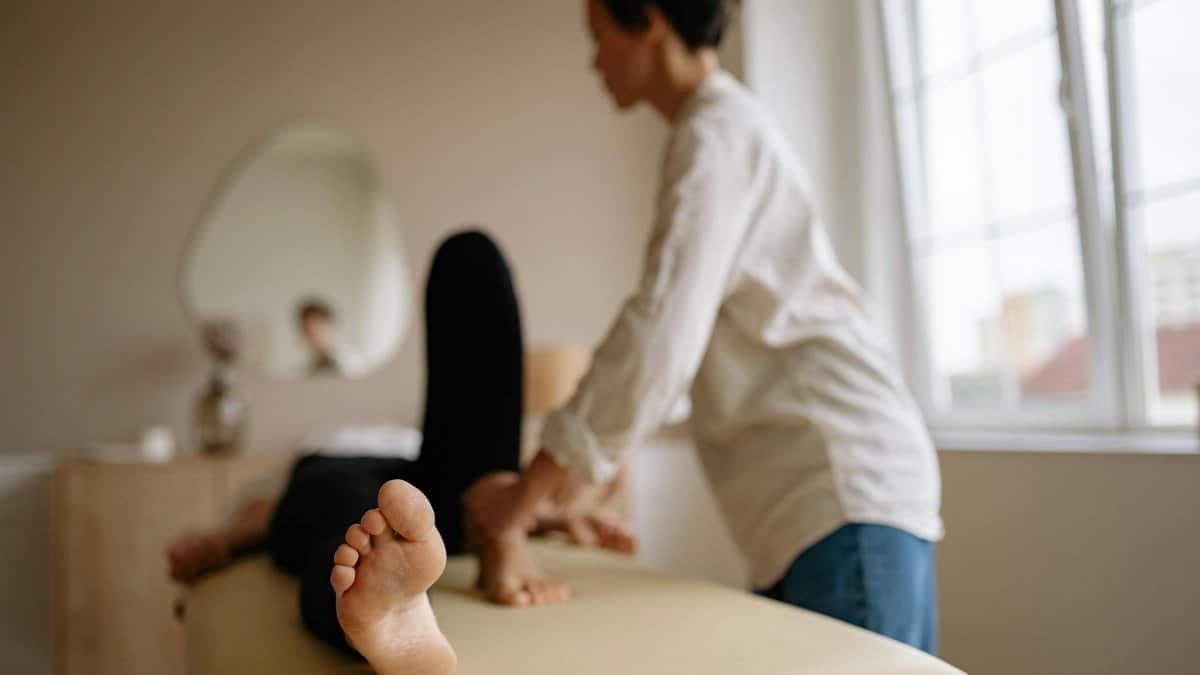 A calming foot massage in a serene indoor spa environment with natural light.