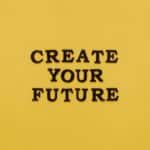 Bold text 'CREATE YOUR FUTURE' on minimalist yellow background. Inspiring design.