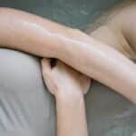 A serene image of a person relaxing in a bathtub, highlighting smooth skin.