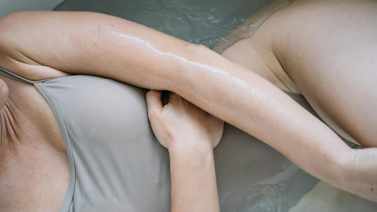 A serene image of a person relaxing in a bathtub, highlighting smooth skin.