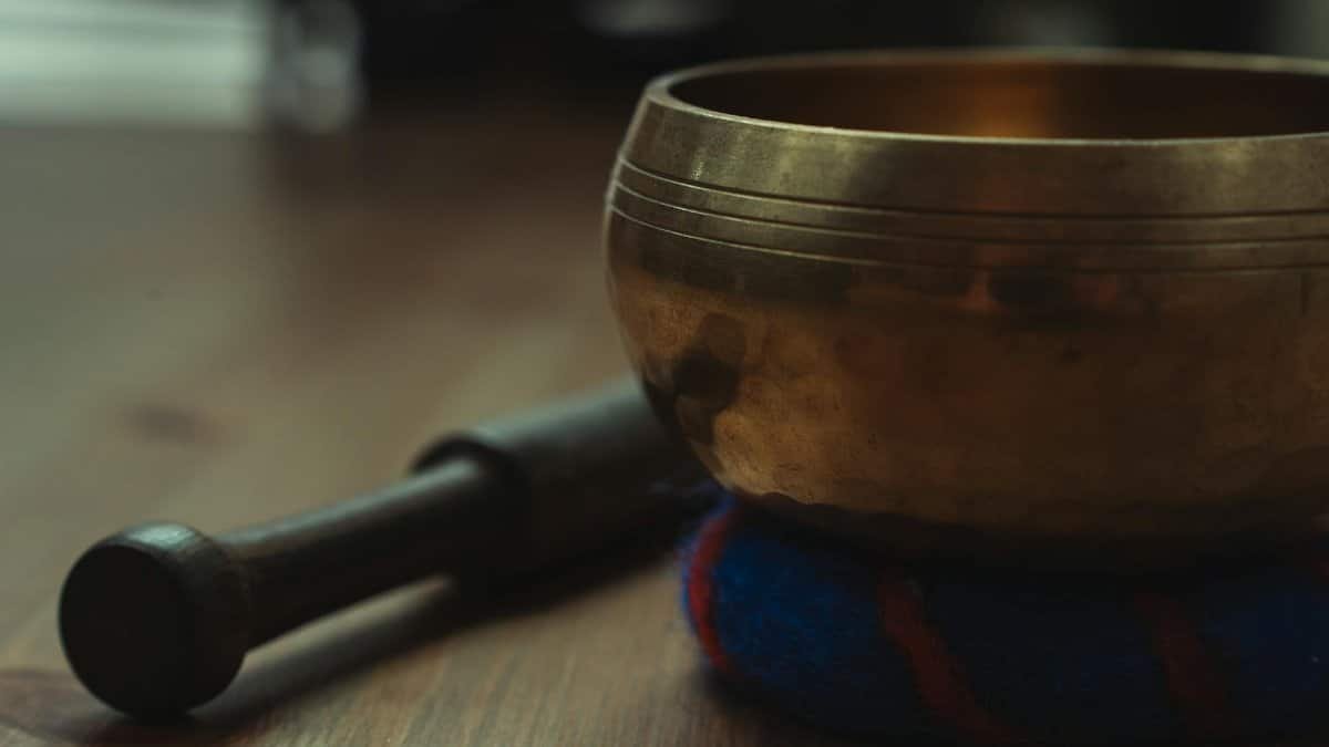 Close-up of a Tibetan singing bowl on a wooden table, ideal for sound therapy and relaxation.