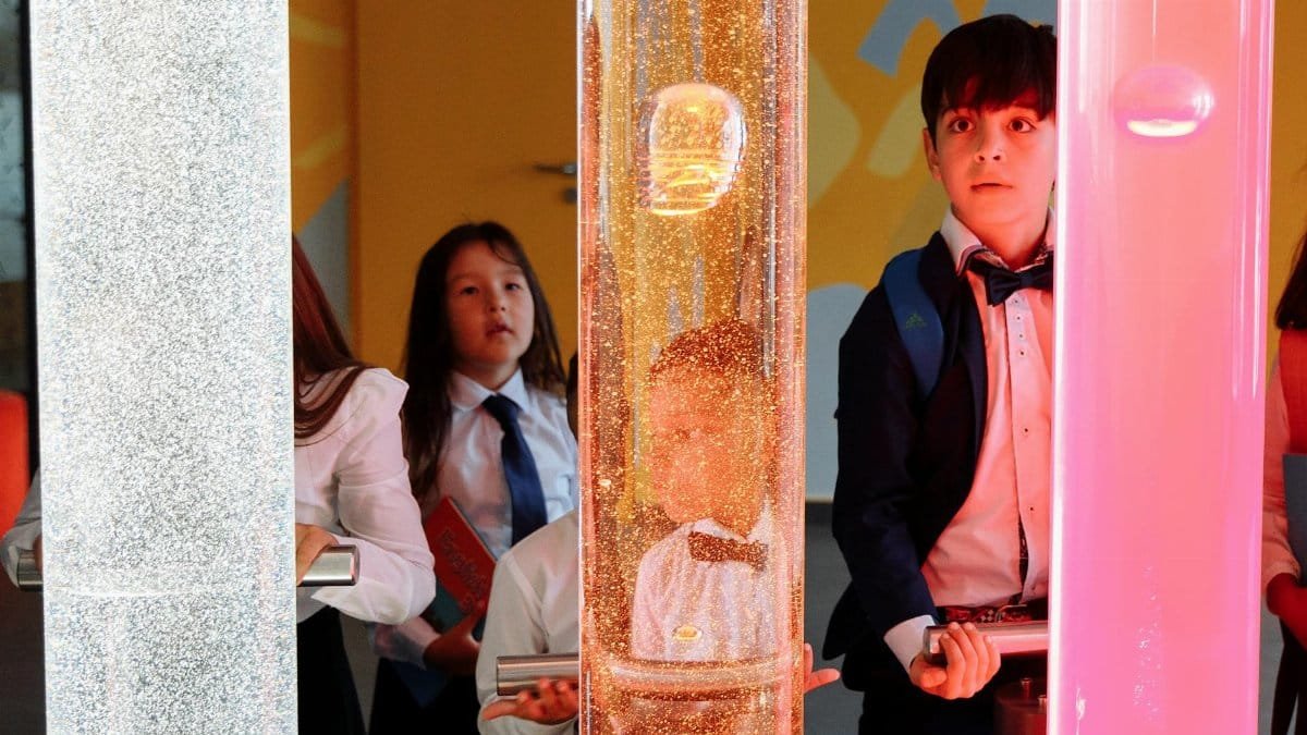 Kids engaging with a colorful science exhibit, sparking curiosity and learning through hands-on interaction.