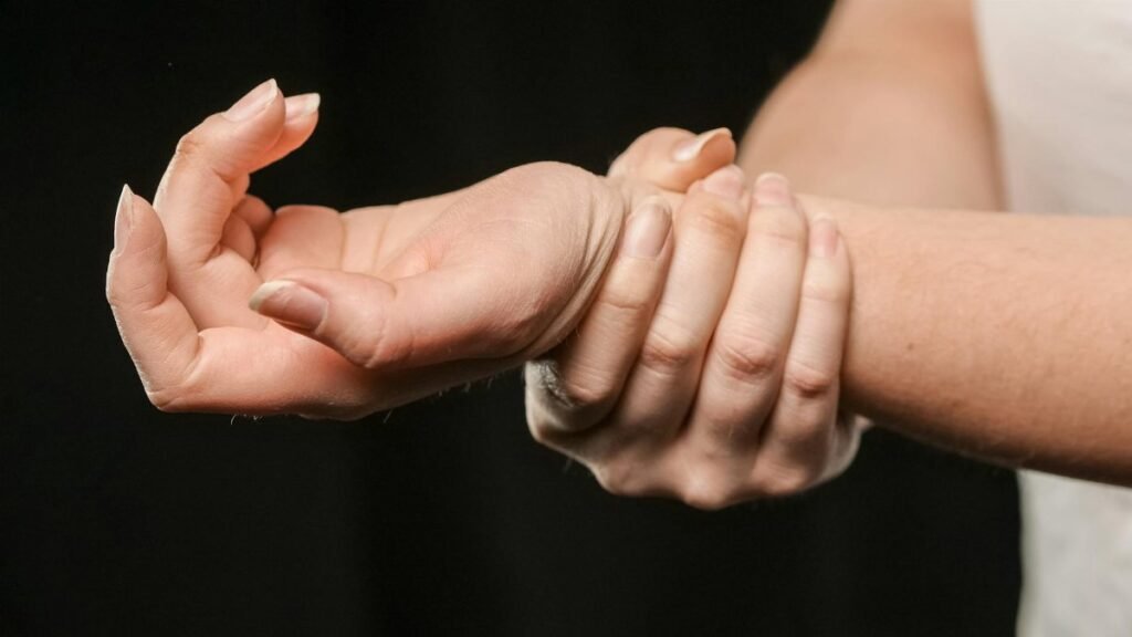 A close-up image of hands grasping a wrist, showcasing human connection and support.