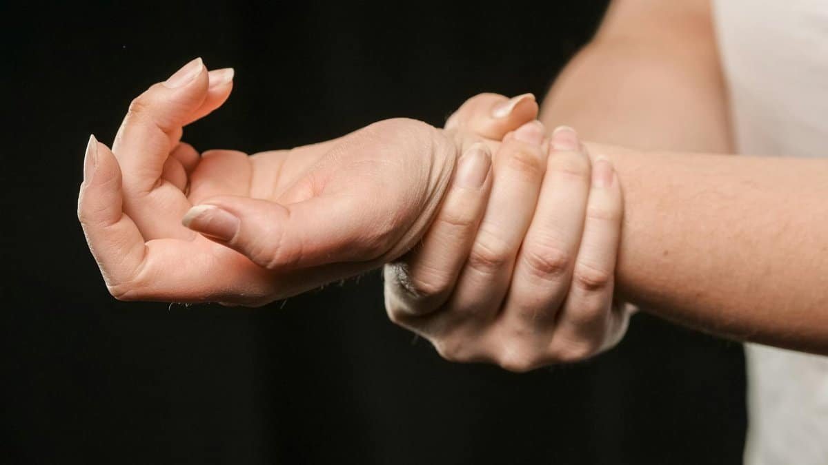 A close-up image of hands grasping a wrist, showcasing human connection and support.