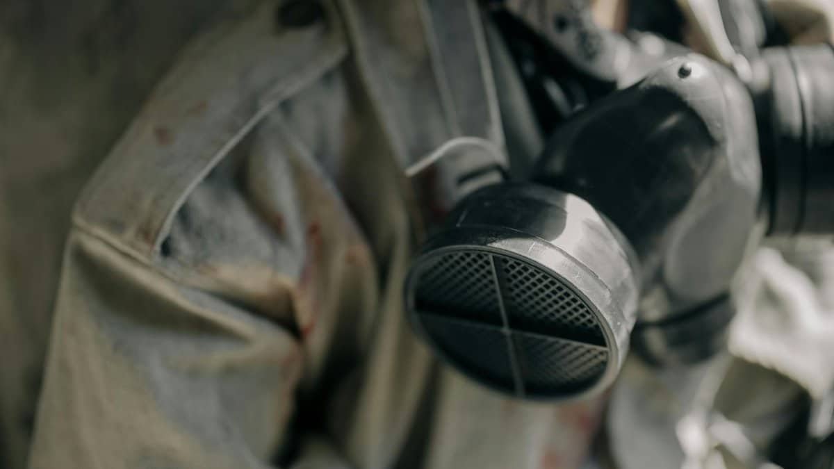 Detailed image of a respirator and protective suit, signifying safety in hazardous environments.