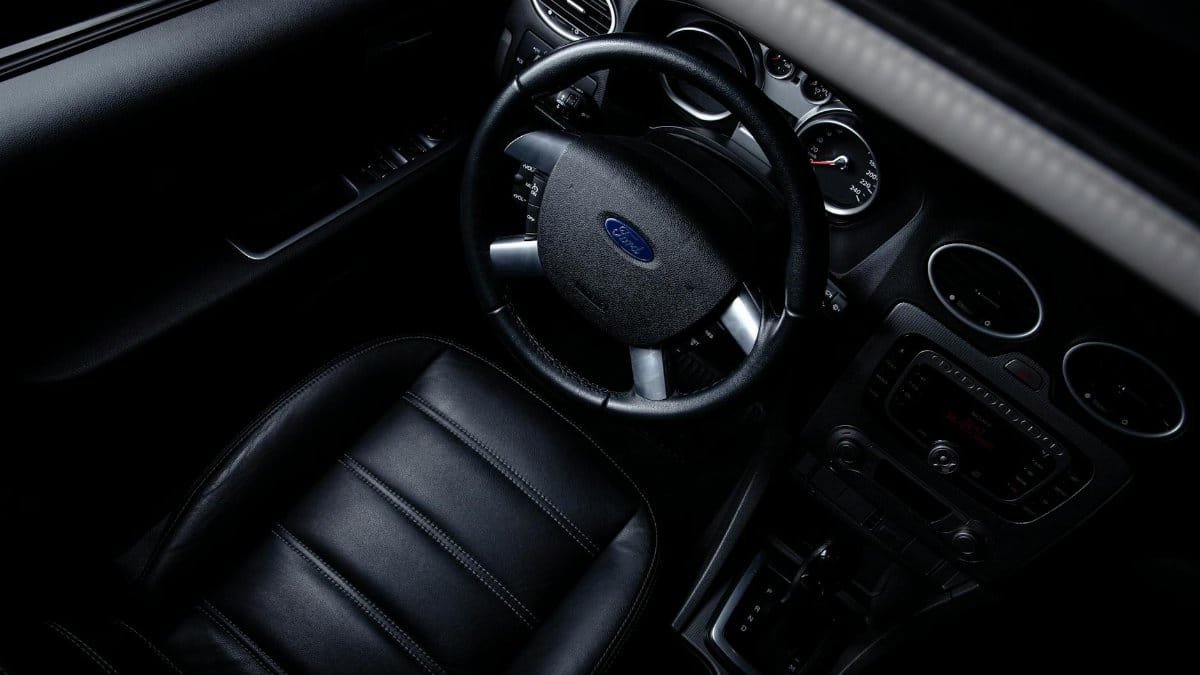 Modern black Ford car interior showcasing luxurious design with leather seats and dashboard from above.