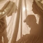 Silhouettes of a family playing inside a decorated tent with soft lights.