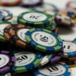 Stacked Las Vegas poker chips showcasing different denominations on a white surface.