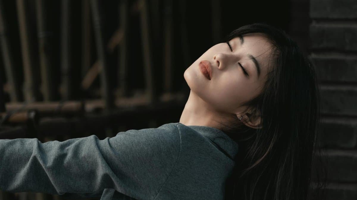 Serene close-up of a woman with closed eyes, exuding calm and introspection.