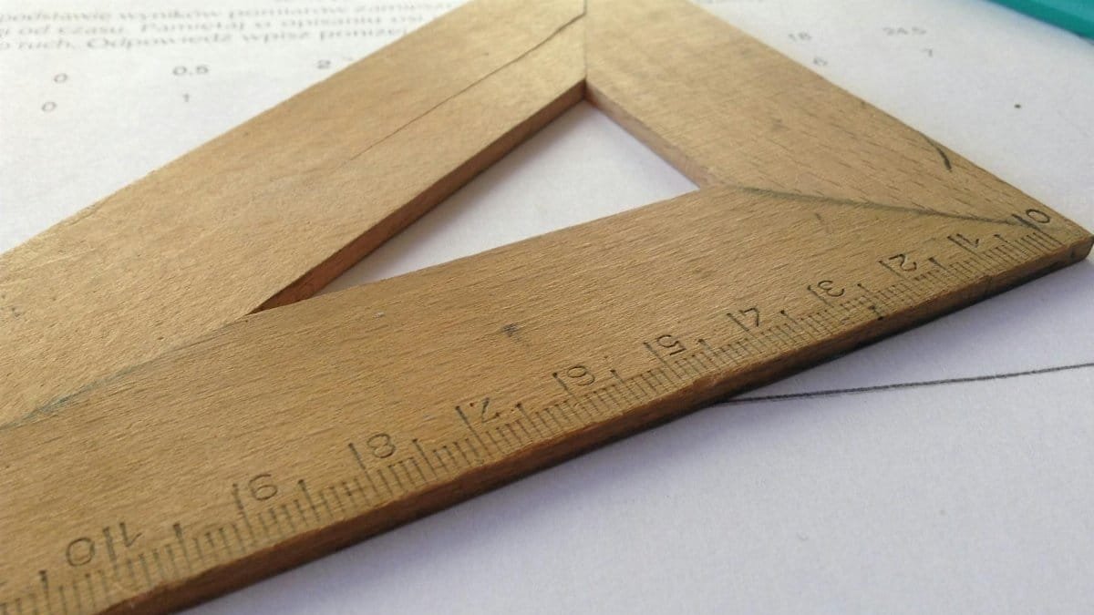 Close-up of a wooden ruler on paper, ideal for educational themes and measuring concepts.