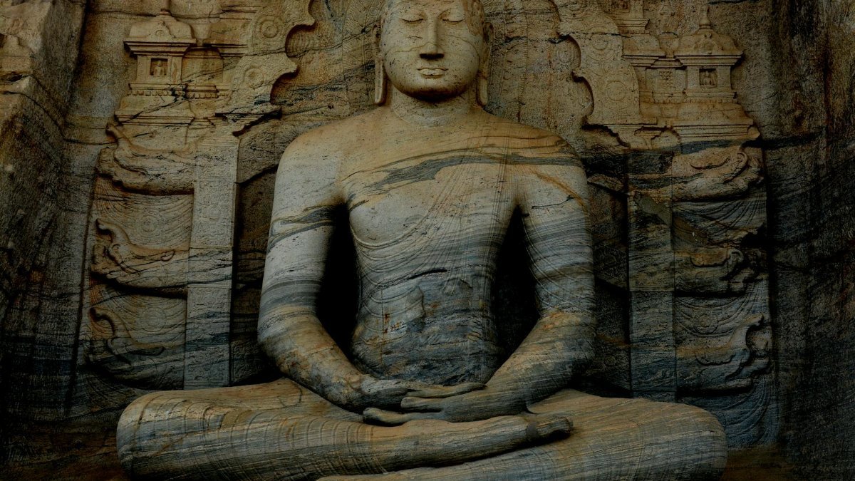 A serene ancient Buddha statue carved in stone at Gal Vihara, Sri Lanka, showcasing historic Buddhist art.