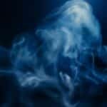 An ethereal composition of swirling blue smoke on a dark background, creating a mysterious and magical atmosphere.