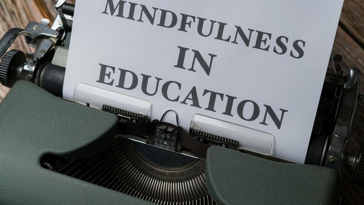 Close-up of a vintage typewriter with 'Mindfulness in Education' paper.